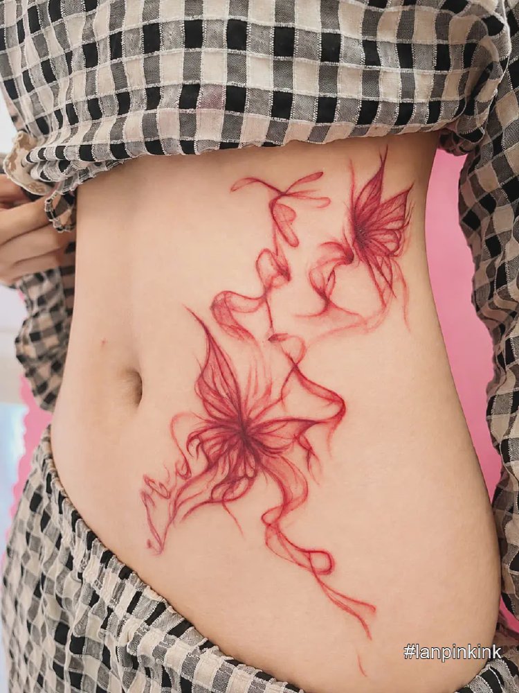 Hình xăm bướm khói đỏ trên hông tại Lanpink Tattoo Quận 12